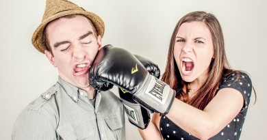 Woman punches man with boxing glove