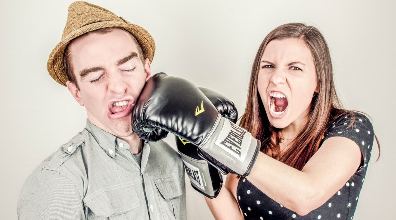 Woman punches man with boxing glove